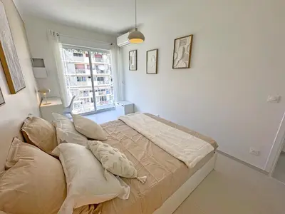 a bedroom with a bed with pillows and a window at Nice Seaview Loft Promenade in Nice