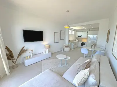 a living room with a couch and a tv at Nice Seaview Loft Promenade in Nice