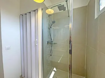 a shower with a glass door in a bathroom at Nice Seaview Loft Promenade in Nice