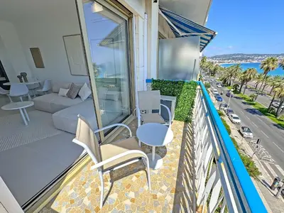 a balcony with a couch and a table and chairs at Nice Seaview Loft Promenade in Nice