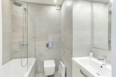 a bathroom with a toilet and a sink and a shower at Jardin tropical, parking, climatisation in Nice