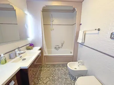 a bathroom with a toilet and a sink and a shower at Panoramic Pebbles Azur in Nice
