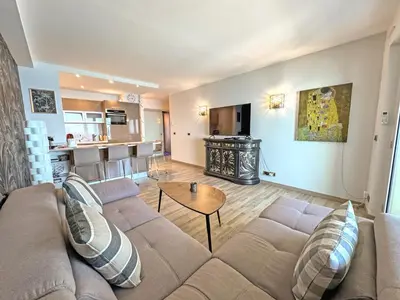 a living room with a couch and a table at Panoramic Pebbles Azur in Nice