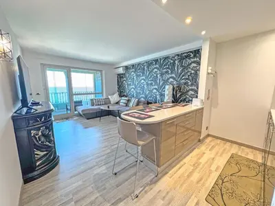 a kitchen with a desk and a living room at Panoramic Pebbles Azur in Nice