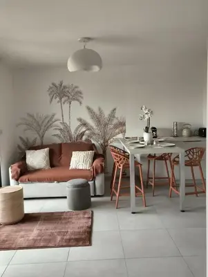 a living room with a couch and a table at Piscine Rooftop Résidence Neuve in Saint-Laurent-du-Var