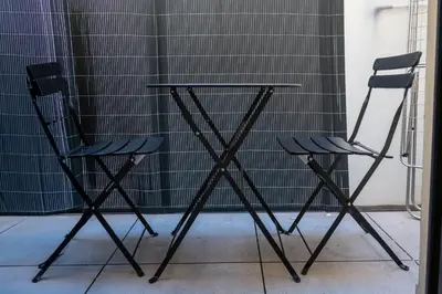 two chairs and a table in a room at Gambetta stay near attractions in Nice