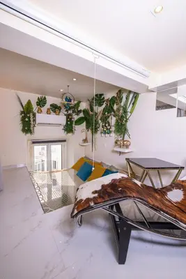 a living room with a couch and potted plants at Duplex suite 50m de la plage Carré d'Or Nice in Nice