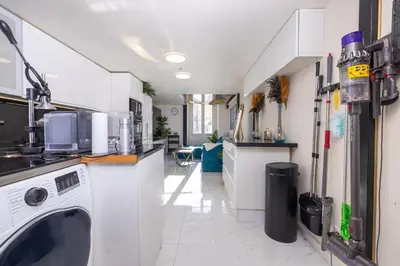 a kitchen with a washing machine in a room at Duplex suite 50m de la plage Carré d'Or Nice in Nice