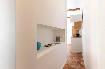 a room with a white wall with a blue vase on a shelf at NEW Appartement vieux Nice à côté de la plage AC in Nice