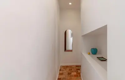 a hallway with a white wall and a mirror at NEW Appartement vieux Nice à côté de la plage AC in Nice