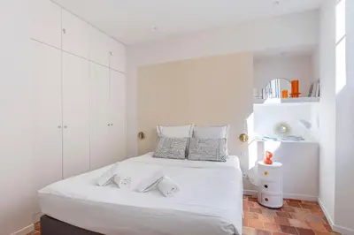 a white bedroom with a bed with two towels on it at NEW Appartement vieux Nice à côté de la plage AC in Nice