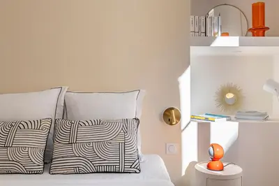 a bedroom with a bed with two pillows and a shelf at NEW Appartement vieux Nice à côté de la plage AC in Nice