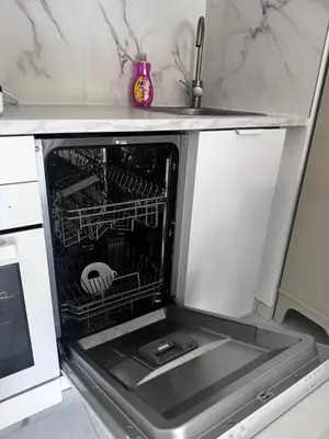 a dishwasher with its door open in a kitchen at Luxueux appartement climatisé avec piscine & parking in Saint-Laurent-du-Var