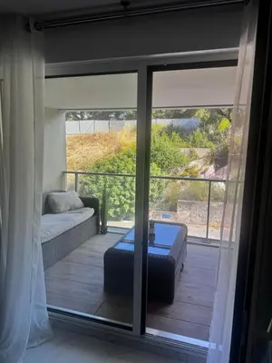 a view of a living room with a sliding glass door at Luxueux appartement climatisé avec piscine & parking in Saint-Laurent-du-Var