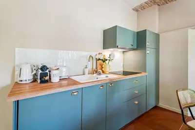a kitchen with blue cabinets and a sink at Nice Renting - CROTTI - Authentic Immersion Sea & Beach Massena in Nice