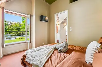 a bedroom with a bed and a large window at Nice Renting - CROTTI - Authentic Immersion Sea & Beach Massena in Nice