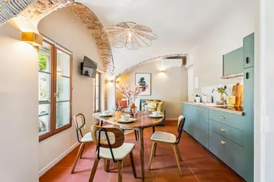 a kitchen and dining room with a table and chairs at Nice Renting - CROTTI - Authentic Immersion Sea & Beach Massena in Nice