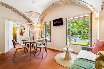 a living room with a table and a couch at Nice Renting - CROTTI - Authentic Immersion Sea & Beach Massena in Nice