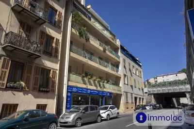a street with cars parked in front of a building at Air-conditioned apartment in the Carras district close to the sea in Nice