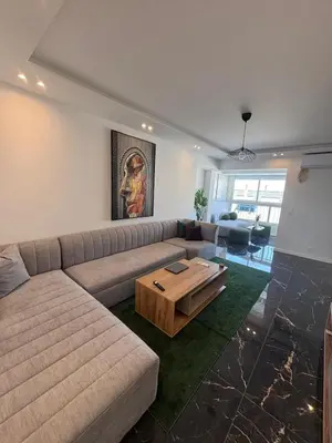a living room with a couch and a coffee table at Air-conditioned apartment in the Carras district close to the sea in Nice
