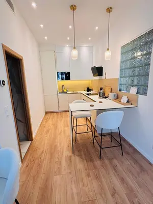 a kitchen with a table and two chairs at Appartement 1 chambre - grande terrasse in Nice