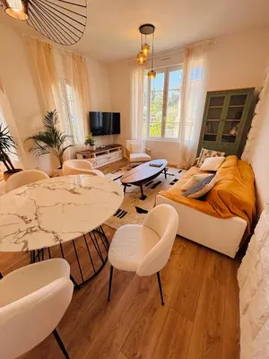 a living room with a bed and a table and chairs at Appartement 1 chambre - grande terrasse in Nice