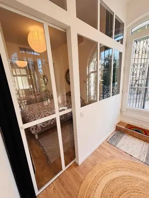 a room with a large glass door with a table at Appartement 1 chambre - grande terrasse in Nice