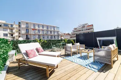 a patio with chairs and a fireplace on a roof at Wide Open Sky Terrace 1 Bdr in Nice