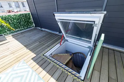 a small opening in a building on a deck at Wide Open Sky Terrace 1 Bdr in Nice