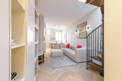 a living room with a couch and a table at Wide Open Sky Terrace 1 Bdr in Nice