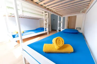 a bedroom with two bunk beds and a yellow towel at Grand appartement idéal famille, proche plage, bon emplacement pour visiter la Côte d'Azur in Nice