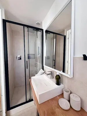 a bathroom with a white sink and a shower at L'appart in Nice