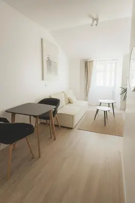 a living room with a couch and a table at Magnifique appartement Carré Or in Nice