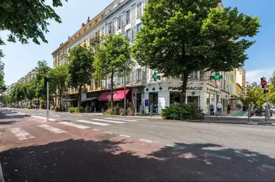 an empty city street with trees and buildings at Magnifique appartement Carré Or in Nice
