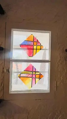 two colorful kites in a window in a room at Sublime T3 havre de paix rénové climatisé Parking in Nice