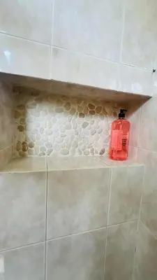 a red soap bottle sitting on a shelf in a shower at Sublime T3 havre de paix rénové climatisé Parking in Nice