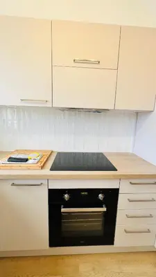 a kitchen with a black stove top oven at Sublime T3 havre de paix rénové climatisé Parking in Nice