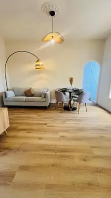 a living room with a couch and a table at Sublime T3 havre de paix rénové climatisé Parking in Nice