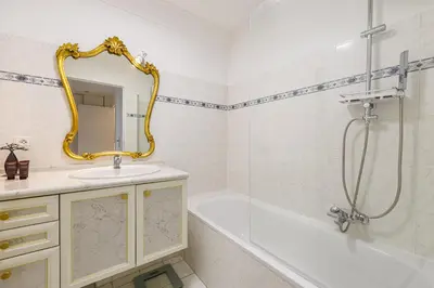 a bathroom with a tub and a sink and a mirror at FEEL HOME - CAIS De PIERLAS in Nice