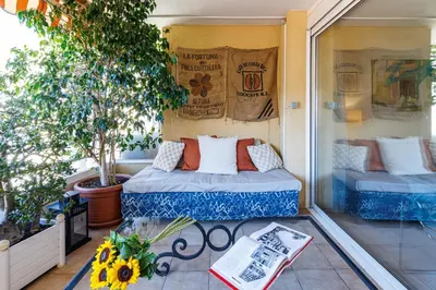 a small balcony with two beds on a porch at FEEL HOME - CAIS De PIERLAS in Nice