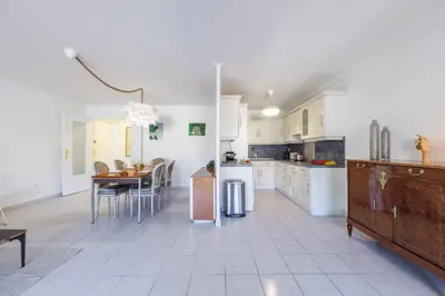 a kitchen with a table and a dining room at FEEL HOME - CAIS De PIERLAS in Nice