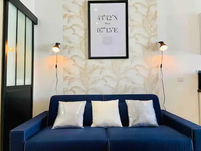 a blue couch with two pillows in a living room at Magnifique studio Centre-ville in Nice