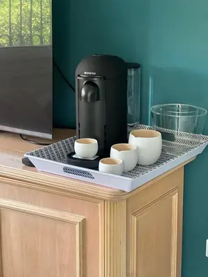 a coffee maker and three cups on a counter at Studio du Domaine du Piol in Nice