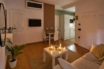 a living room with a couch and a table with candles at Vieux Nice Design & confort Mer à 2 min in Nice