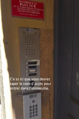 a sign on the side of a building with a pay phone at Vieux Nice Design & confort Mer à 2 min in Nice