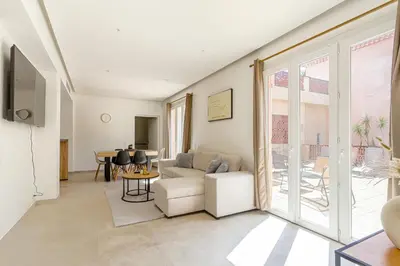 a living room with a couch and a table at Sàvega - Climatisé et Proche Plage in Nice