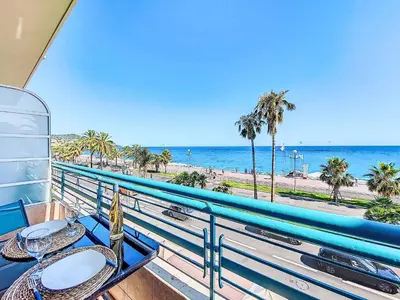 a balcony with a table and a view of the beach at Studio Le Savoy Promenade des Anglais-5 by Interhome in Nice