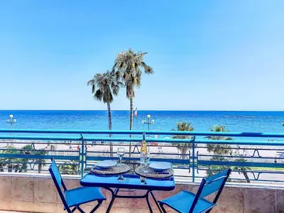 a table and chairs on a balcony overlooking the ocean at Studio Le Savoy Promenade des Anglais-5 by Interhome in Nice