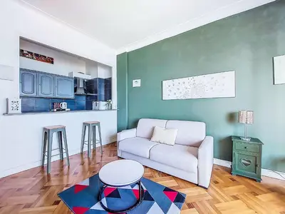 a living room with a couch and a table at Studio Le Savoy Promenade des Anglais-5 by Interhome in Nice