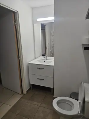 a bathroom with a white toilet and a sink at Résidence le vernier in Nice